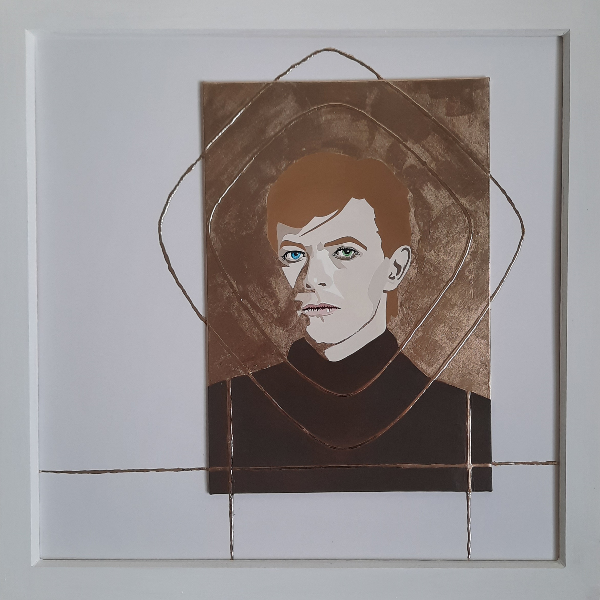 a stunning original portrait painting of david bowie, looking out to the viewer with intense blue and green eyes. He wears a brown polo neck top and the background of the portrait is pure 23 carat gold leaf. There are lines of rounded squares geometrically surrounding the image, also of gold leaf, and these lines stretch to the edge of the frame. buy painting of david bowie. david bowie wall art, painting of david bowie exhibited at teddington artists group, david bowie fan art